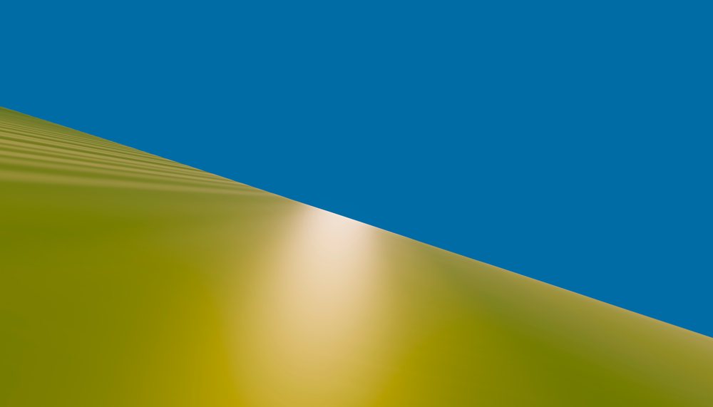 Sand dune with sunlight reflection under a clear blue sky in a desert landscape.