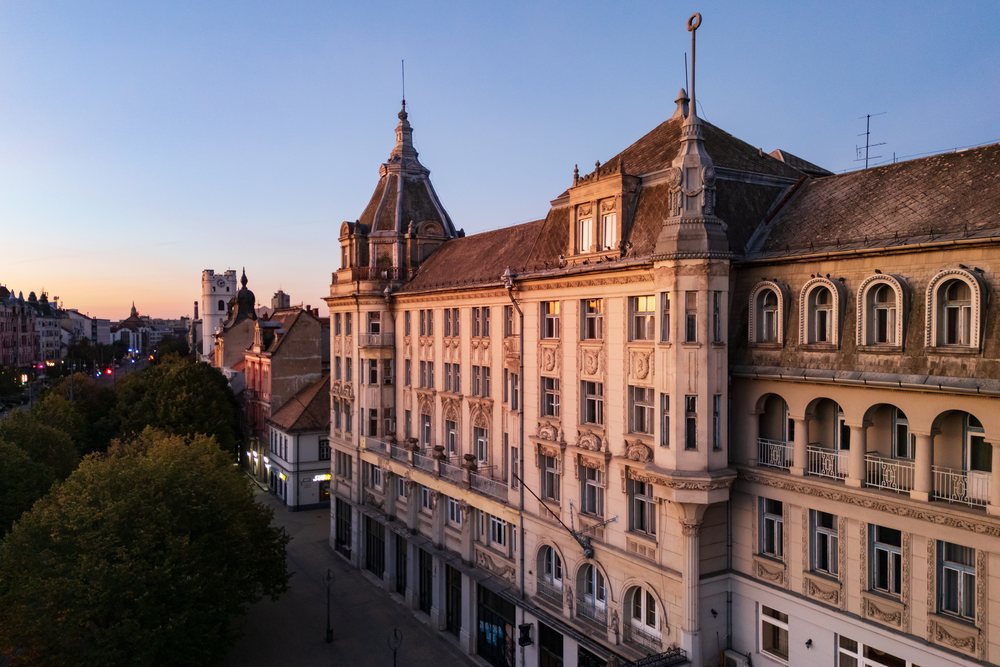 Art Nouveau buildings with ornate facades and roof decorations line Kossuth Square, Cityscape, Débrecen, Hungary.