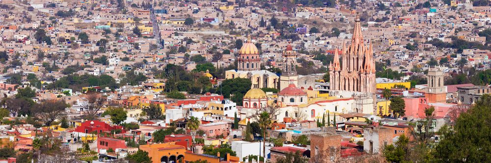 Cityscape of San Miguel de Allende showing colonial churches and colorful buildings, Guanajuato, Mexico.