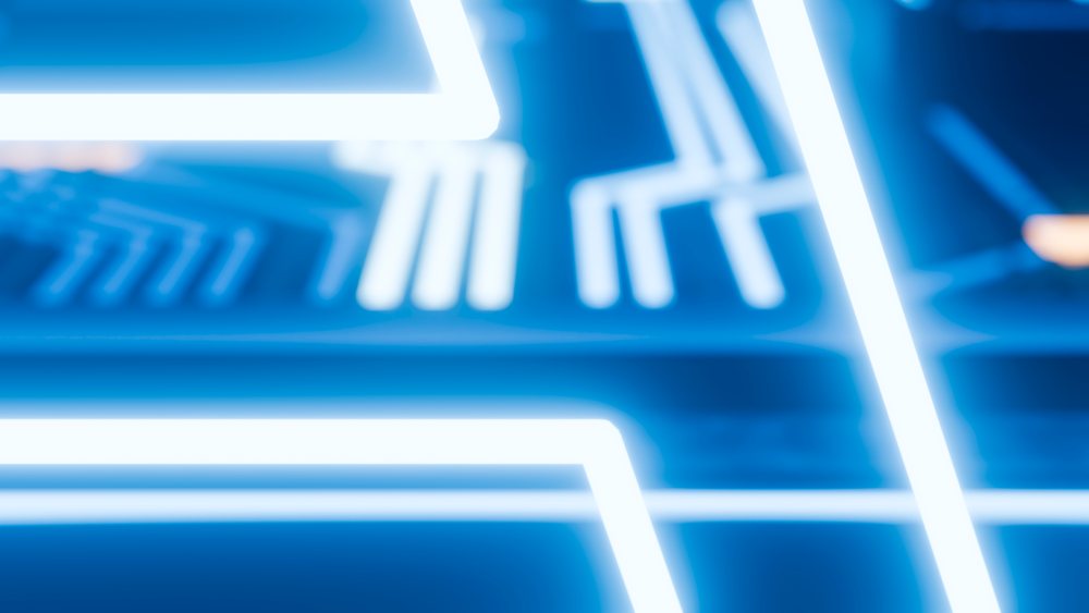 Blue neon lights form glowing geometric shapes with bright electric illumination in a futuristic abstract pattern.