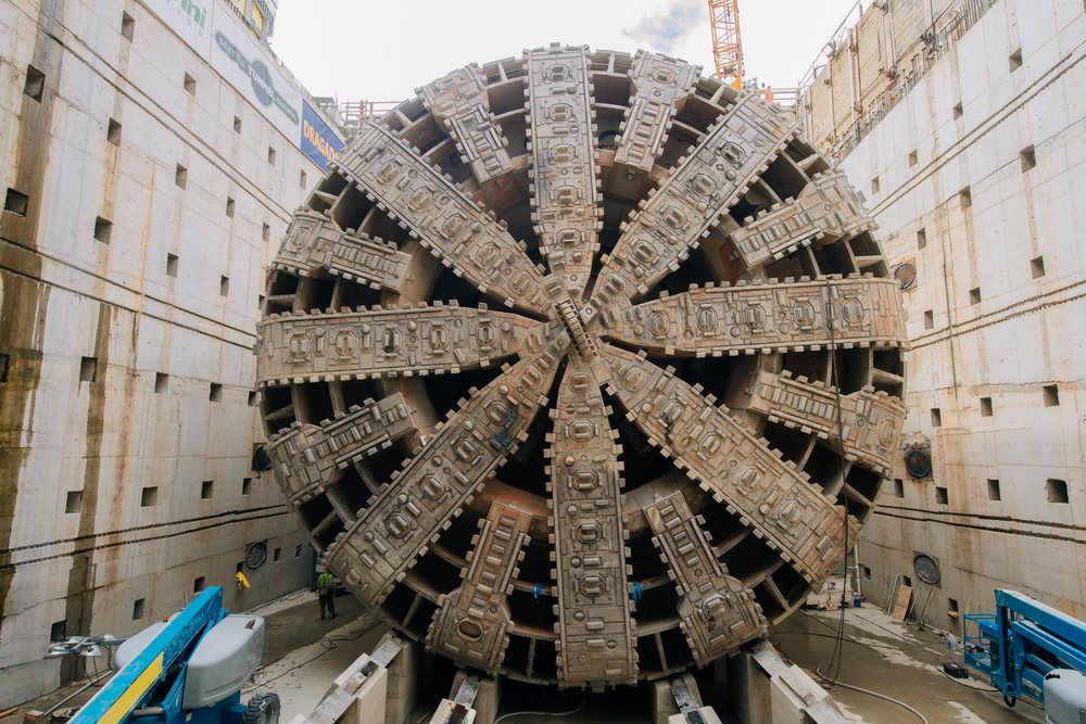 A large tunnel boring machine with a circular drill head positioned in a construction excavation site, Bertha, drilling, USA.