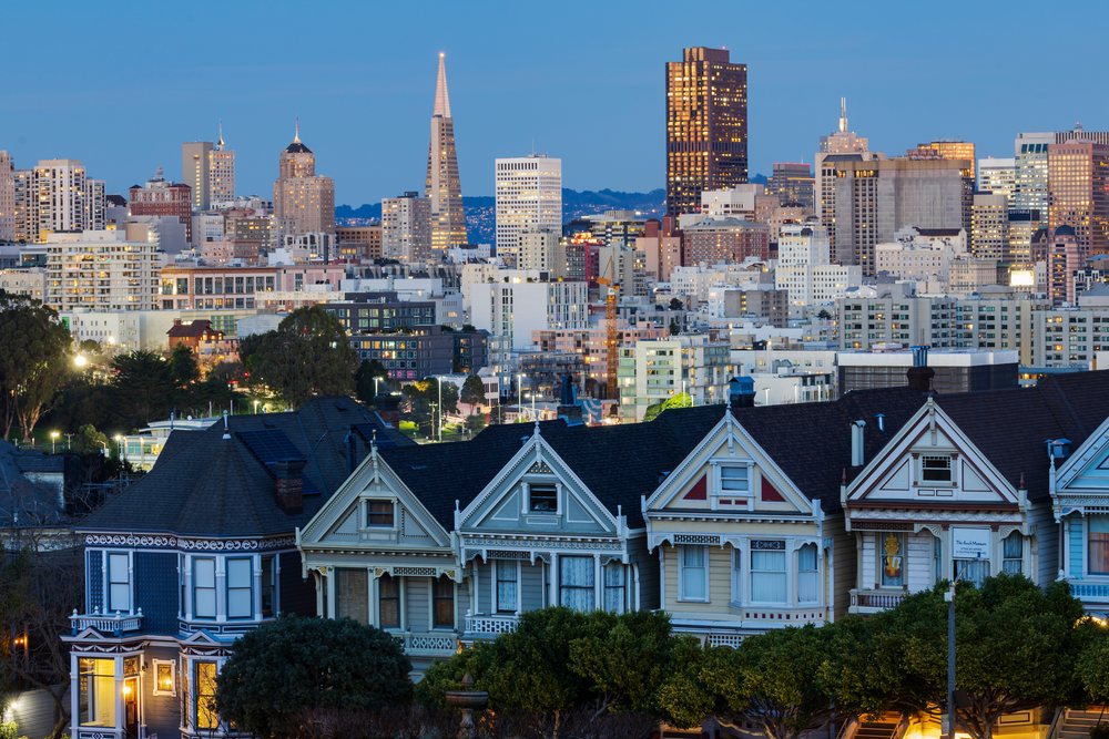San Francisco skyline at twilight with Victorian Painted Ladies houses in the foreground at Steiner Street from Alamo Square, City, Cityscapes, City Life, California, USA.