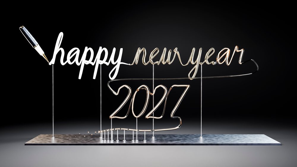 Wire sculpture spelling 'happy new year 2027' in cursive script with a calligraphy pen on a dark background.