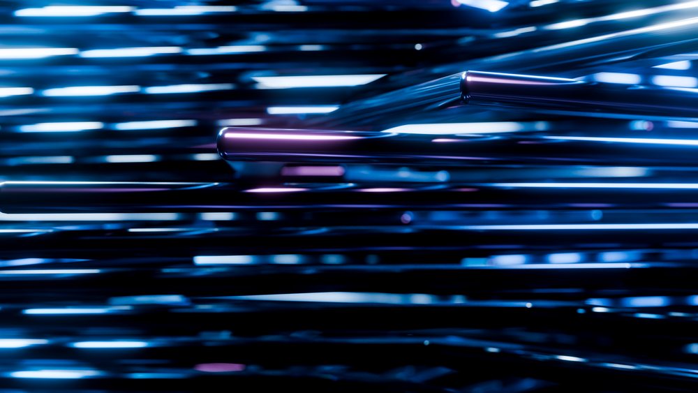 Horizontally arranged shiny metal rods with blue and purple light reflections create an abstract glossy modern design pattern.