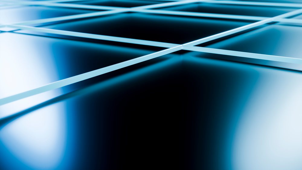 Close-up of intersecting blue glass panes forming a smooth, shiny, geometric, and reflective abstract pattern.