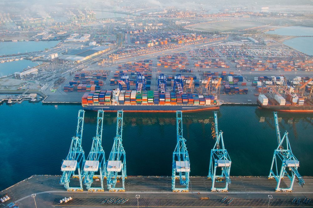 Container ship loaded with colorful shipping containers at cargo cranes in the, Port of Long Beach, CA, USA.