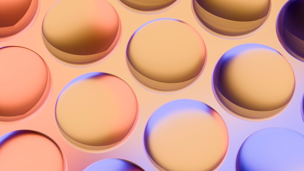 Digital illustration of multiple overlapping orange and purple gradient circles with smooth, glossy surfaces arranged in a modern abstract pattern.