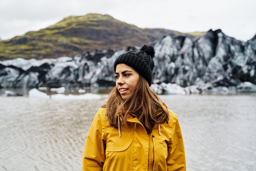 A white woman exploring glacier lake scenery