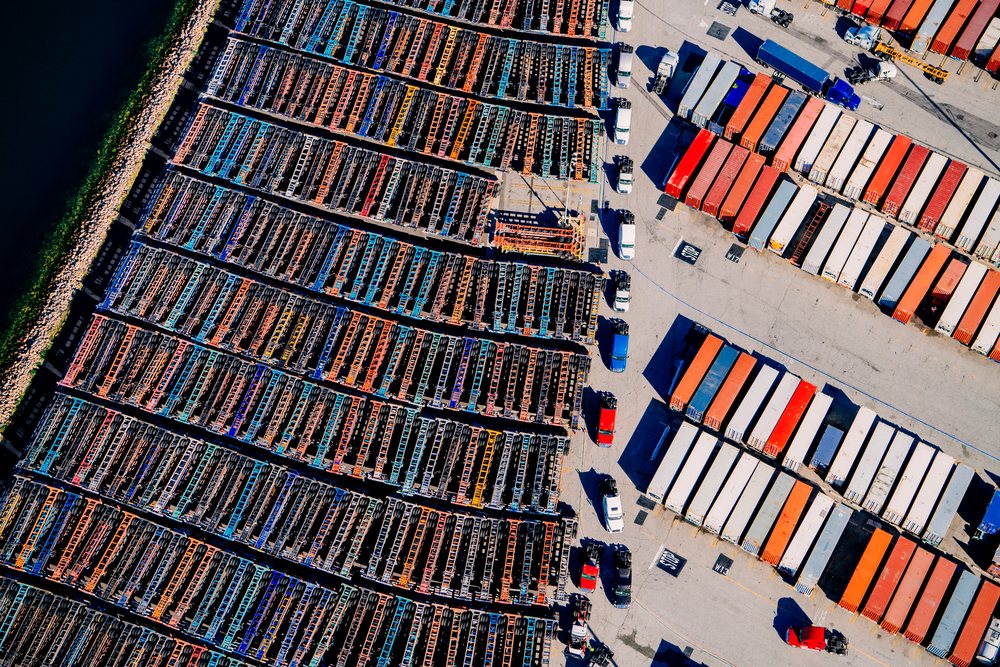 Aerial view of shipping container trucks and colorful stacked containers at a major U.S. port in California, major U.S. port, USA.