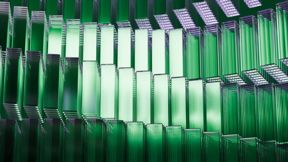 Stacked rectangular transparent green glass panels arranged in an abstract geometric pattern with reflective surfaces.