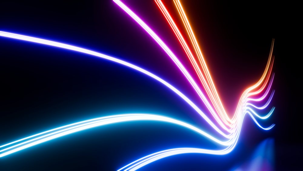 Colorful neon light trails dynamically curve against a dark background in an abstract digital art illustration.