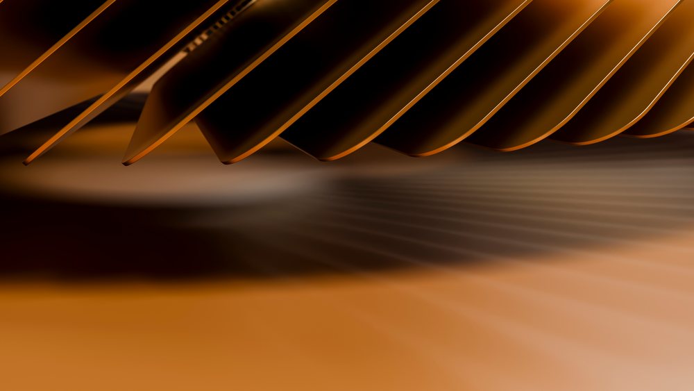 Closeup of golden metallic blades forming an abstract geometric gear pattern in industrial machinery.