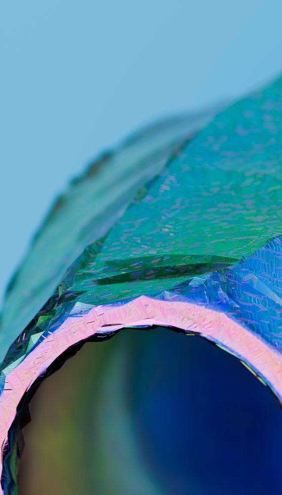 Close-up of a colorful textured glass bottle rim against a blue studio background.