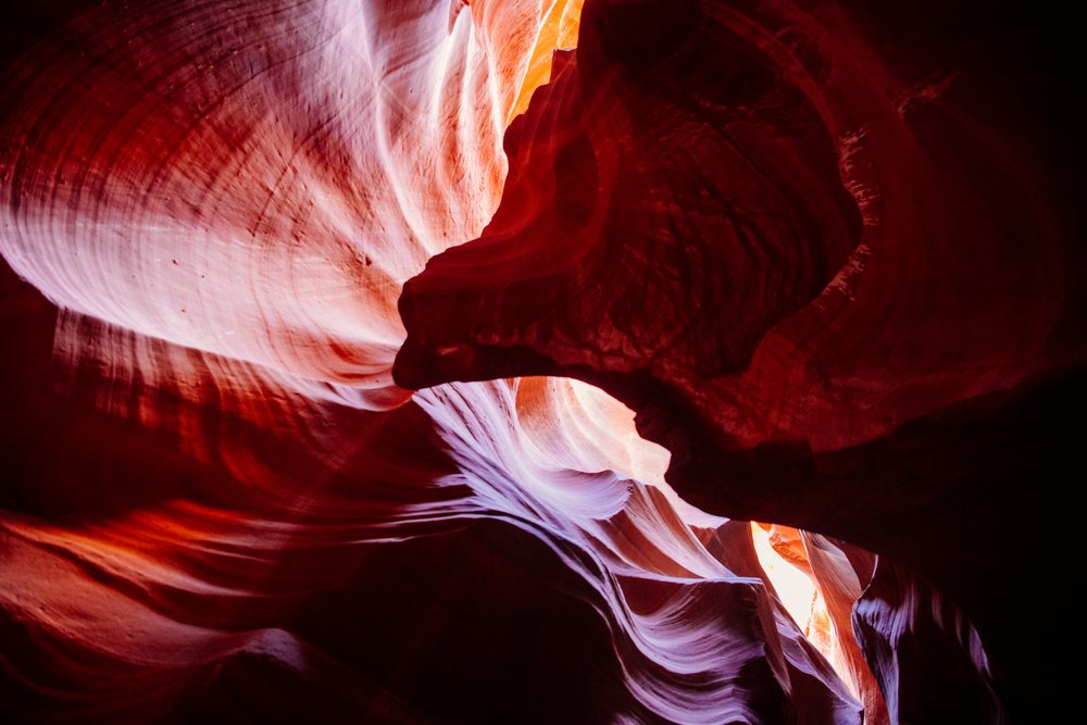 Curved sandstone rock formations illuminated by natural light inside Antelope Canyon slot canyon, Navajo Land, Arizona, USA.