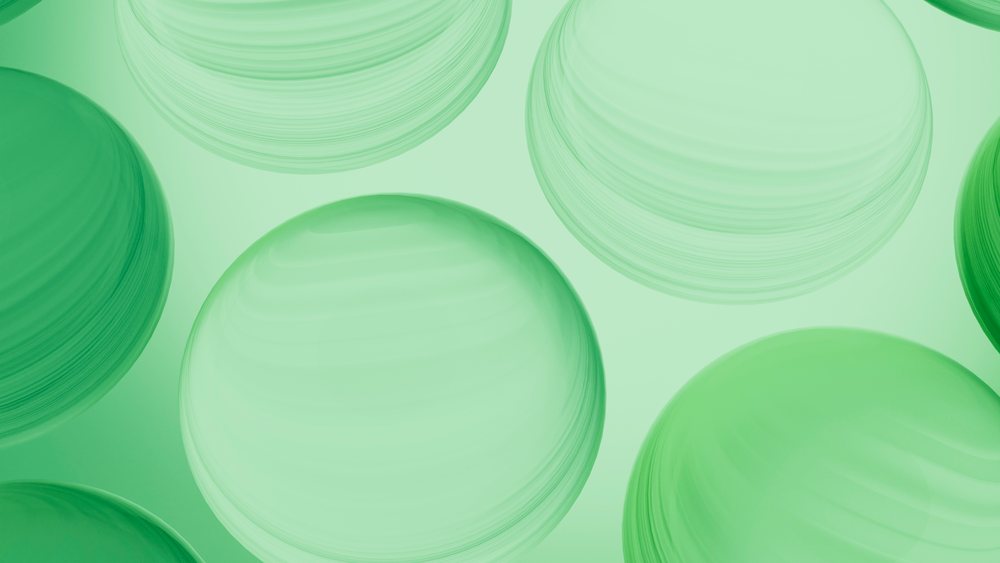 Abstract green translucent spheres with concentric circles float in a modern digital illustration.
