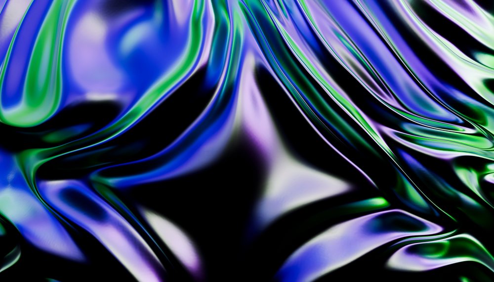 A close-up abstract image showing vibrant glossy blue, green, and purple fluid shapes with smooth undulating textures.
