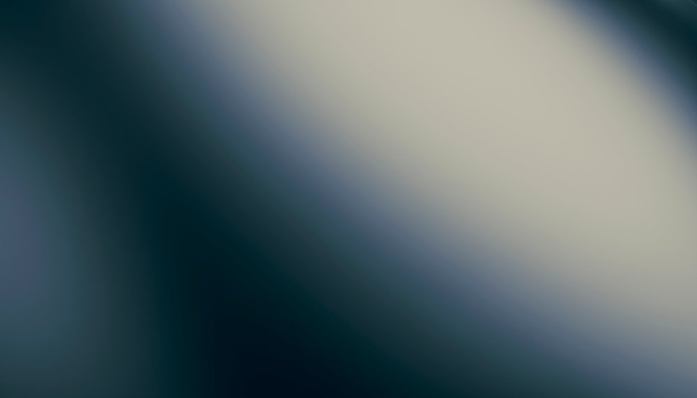 Abstract blurred gradient background with soft neutral tones and smooth color transition.