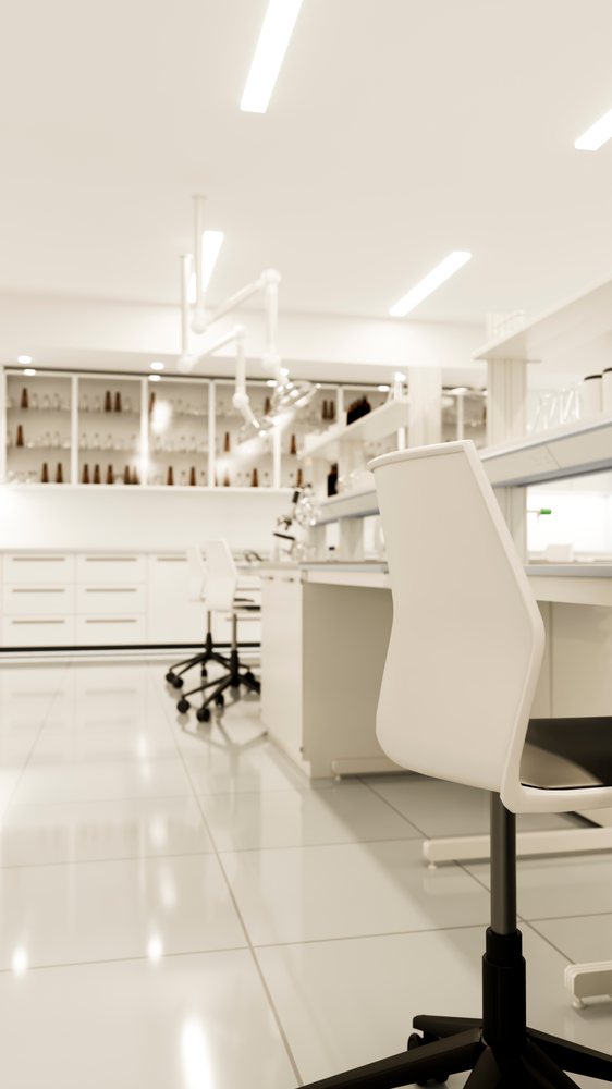 Laboratory workspace featuring white chairs and benches, equipped for scientific research in a clean, modern setting.