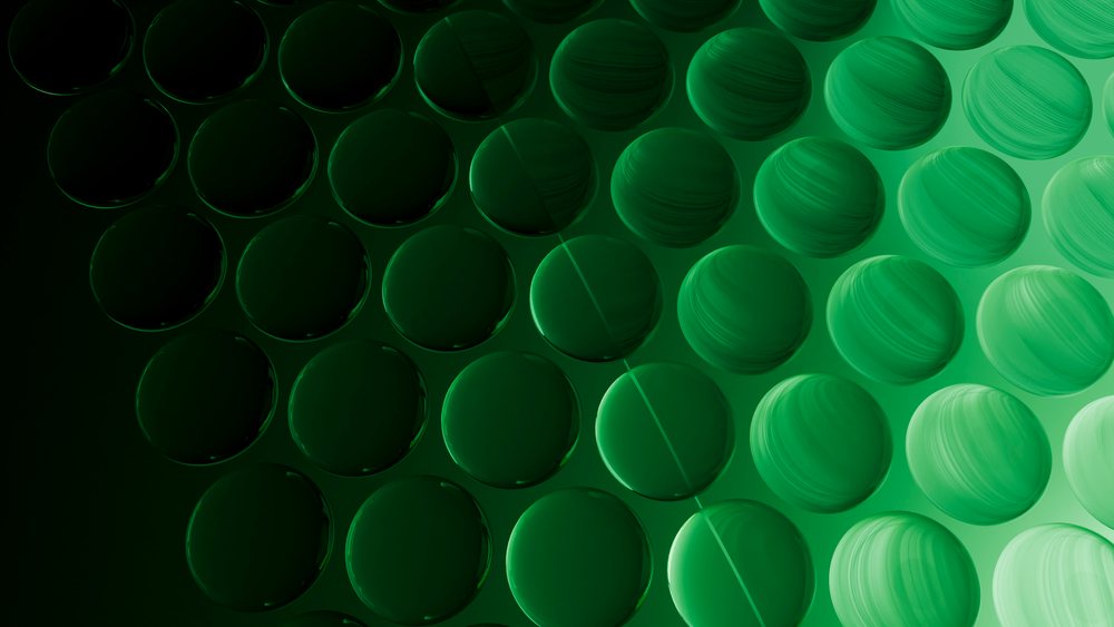 Abstract digital illustration featuring repeating smooth green spheres with gradient lighting in a geometric pattern.