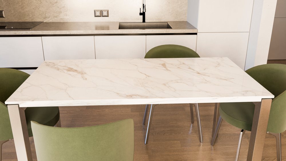 Modern kitchen with a marble dining table, green upholstered chairs, a clean countertop.