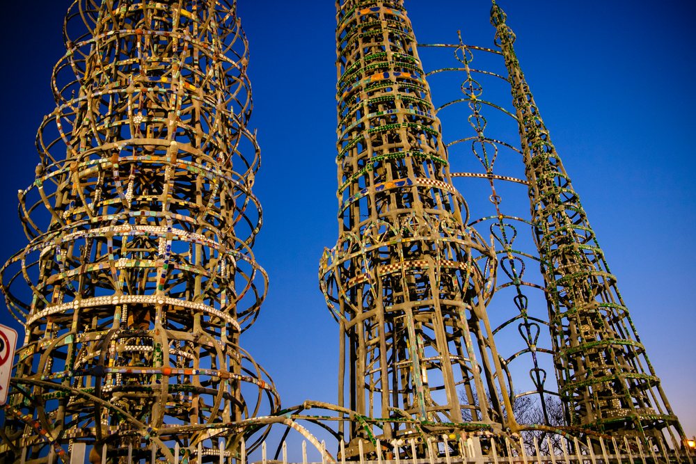 Watts Towers metal towers sculpture with decorative mosaic elements against a clear blue sky, California, USA.