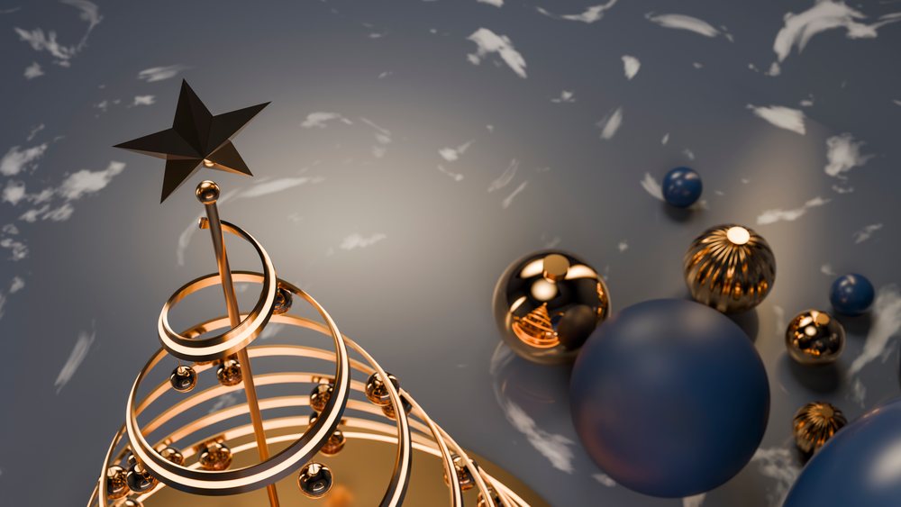Abstract golden Christmas decoration with spiral rings topped by a gold star.