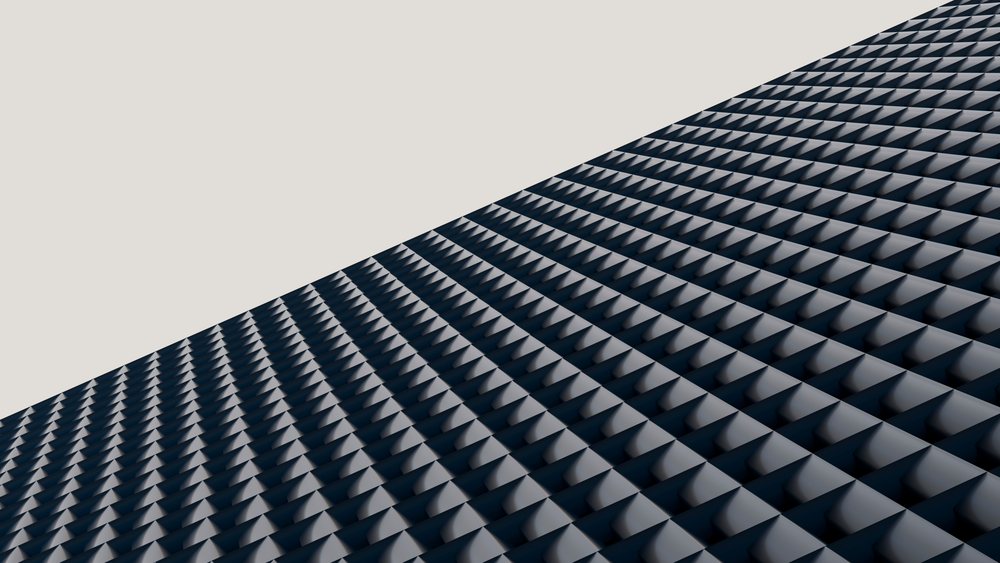 Black triangular patterned architectural surface with repetitive geometric shapes photographed from an angled perspective.