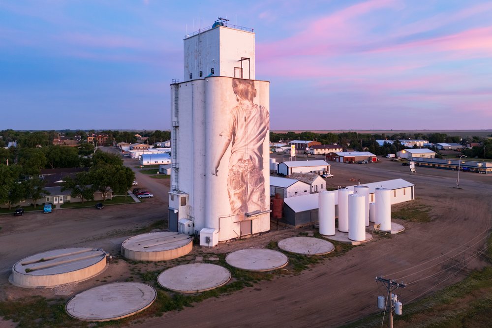 Grain Silo in rural Faulkton, features a large child mural under a pink and blue sunset sky, Storm Chasing, Weather, Environmental, South Dakota, USA.