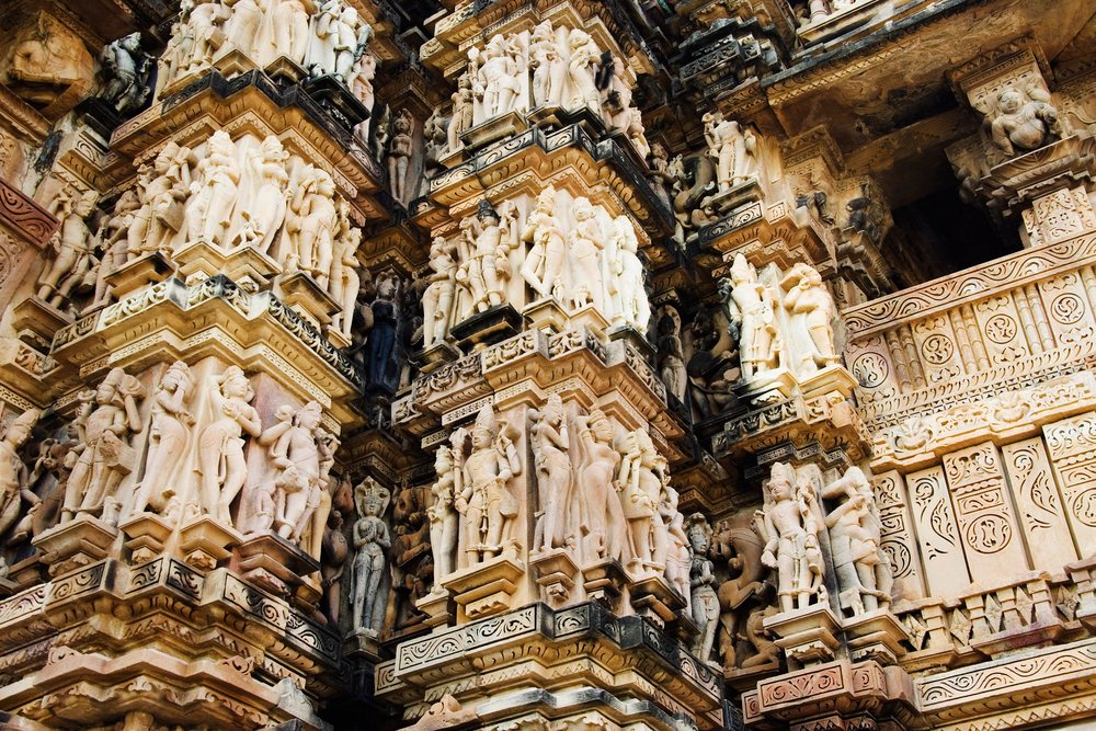 Intricate erotic stone sculptures carved on ancient temple pillars at Khajuraho, Madhya Pradesh, India.