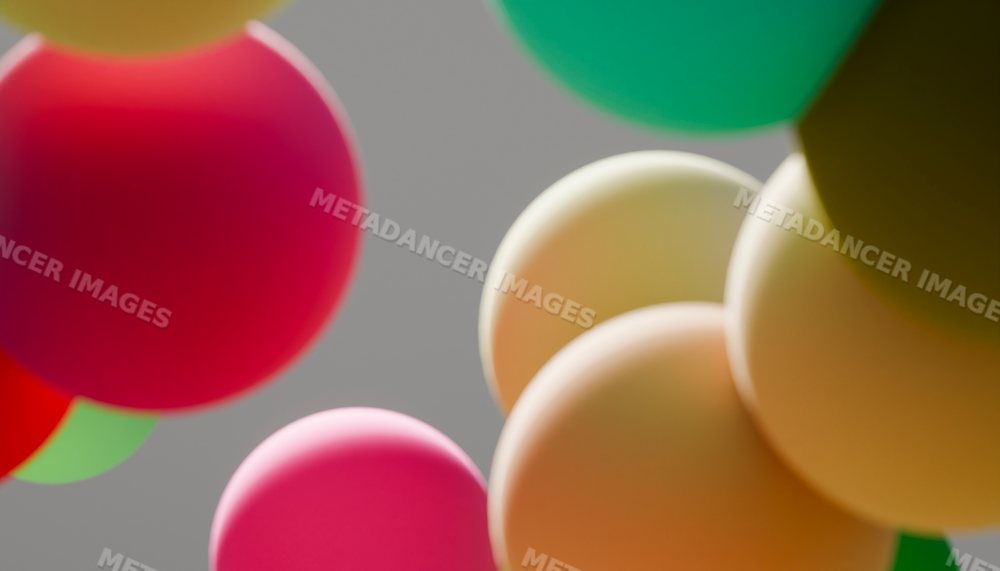 Colorful balloons floating against a gray sky background