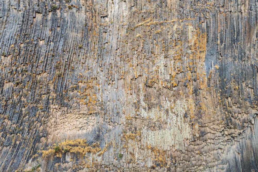Vertical basalt columns form a natural rock cliff face below Garni Temple at Garni Gorge, Armenia.