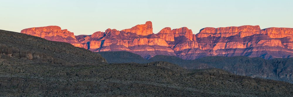 Sunset illuminates the rocky Sierra del Carmen mountain range and desert terrain, landscape, wildlife, Big Bend National Park, Texas, USA.