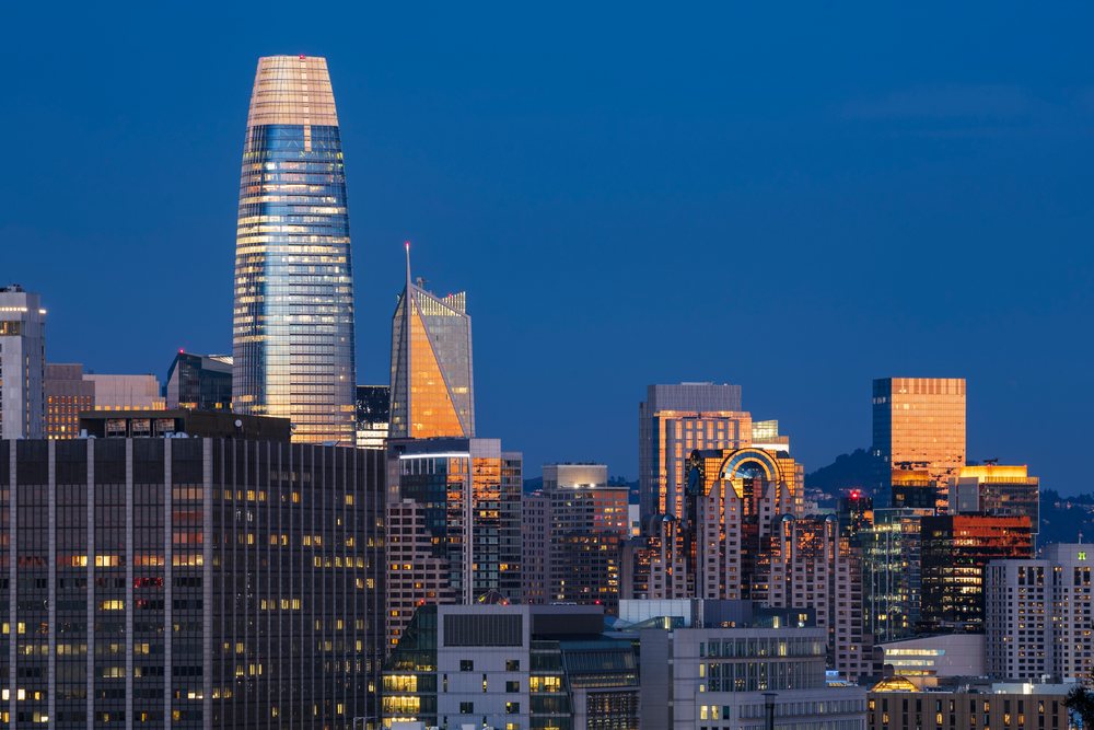 Sunrise illuminates the modern glass skyscrapers of Downtown San Francisco's Skyline, City, Cityscapes, City Life, California, USA.