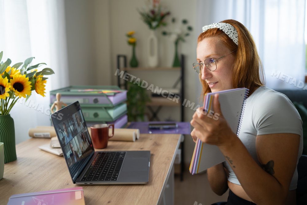 A white woman working from home participates