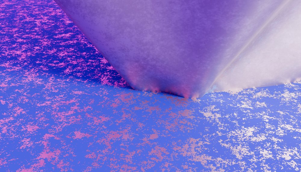 Close-up of a purple cone-shaped object resting on a blue surface with pink speckles, showing a textured abstract design.