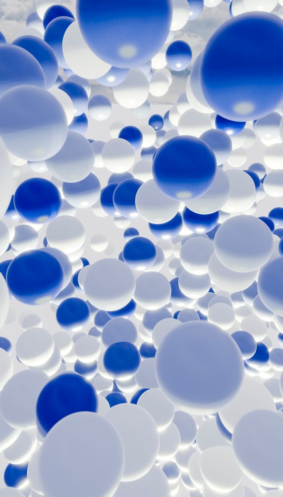 A digital illustration showing numerous blue and white glowing spheres floating against a bright background.