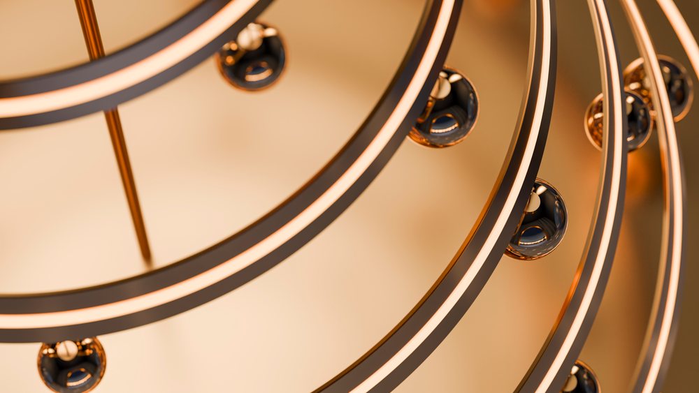 Modern chandelier with circular glowing rings and metallic spheres providing elegant ambient indoor lighting.