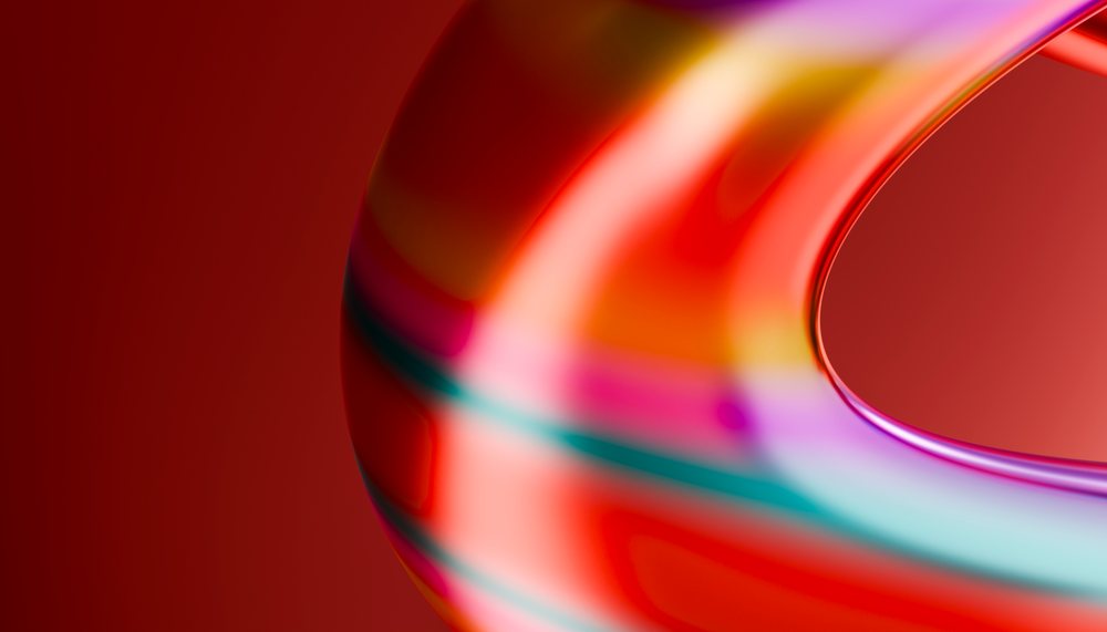 Abstract colorful curved smooth glossy shape with reflections on red background.
