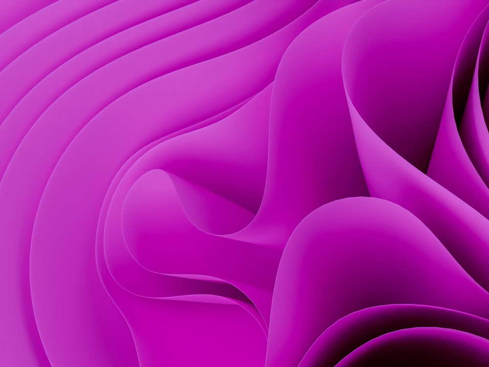 Close-up abstract image of soft purple flowing curves forming smooth folds and waves.