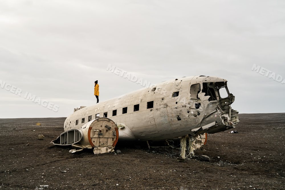 White Person standing on abandoned plane wreck