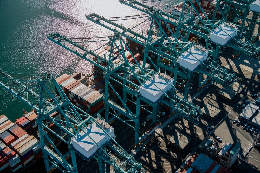 Container cranes loading and unloading shipping containers on a cargo ship in the, Port of Long Beach, CA, USA.