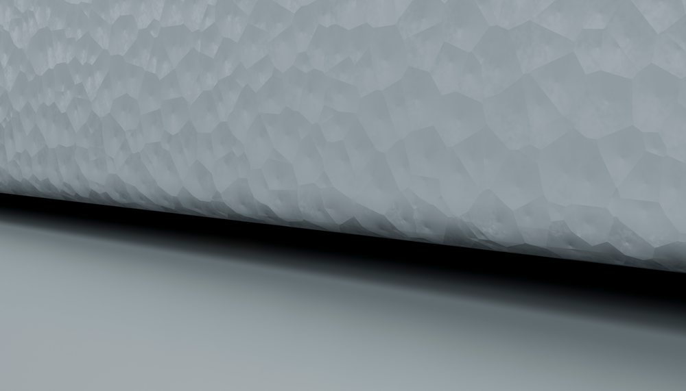 Abstract polygonal grey surface with geometric pattern and gradient shadow in minimalist design.