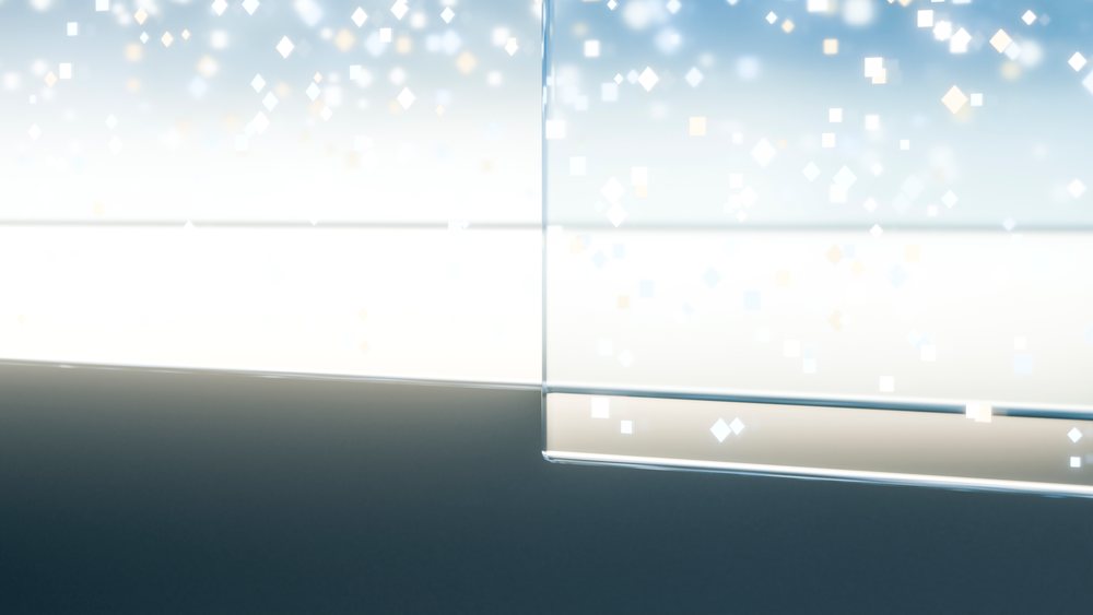 Glass of water with bubbles reflecting light against a blue background.