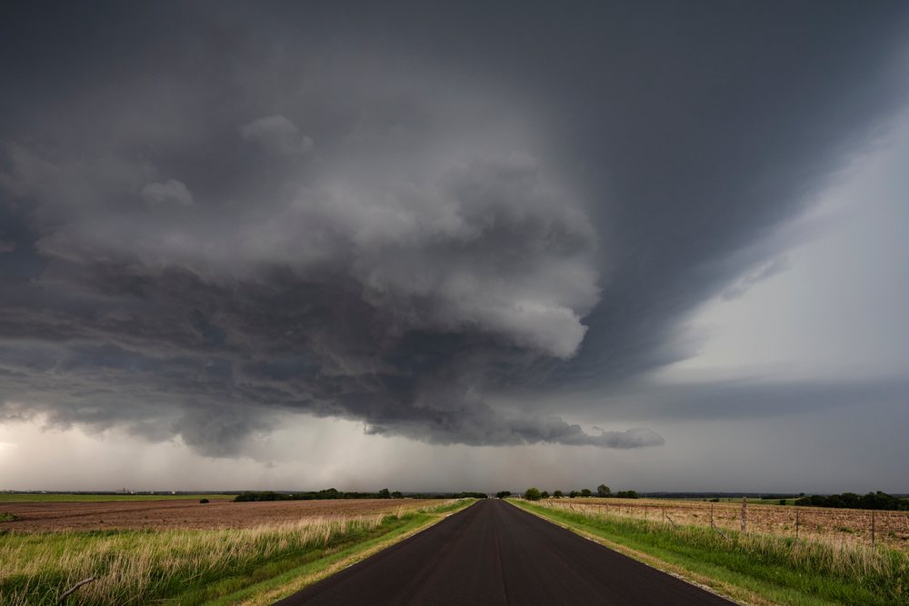Supercell storm forms over open farmland near Salina, under dark threatening skies with rainfall in the distance, Storm Chasing, Weather, Environmental Issues, Abilene, Kansas, USA.