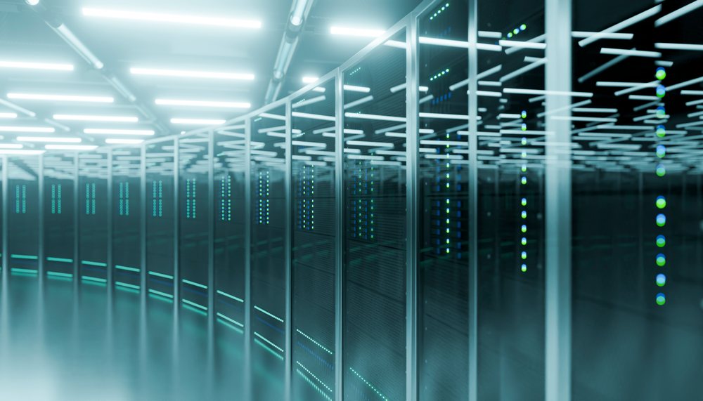 Data center with rows of server racks illuminated by cool blue LED lights in a modern technology facility.