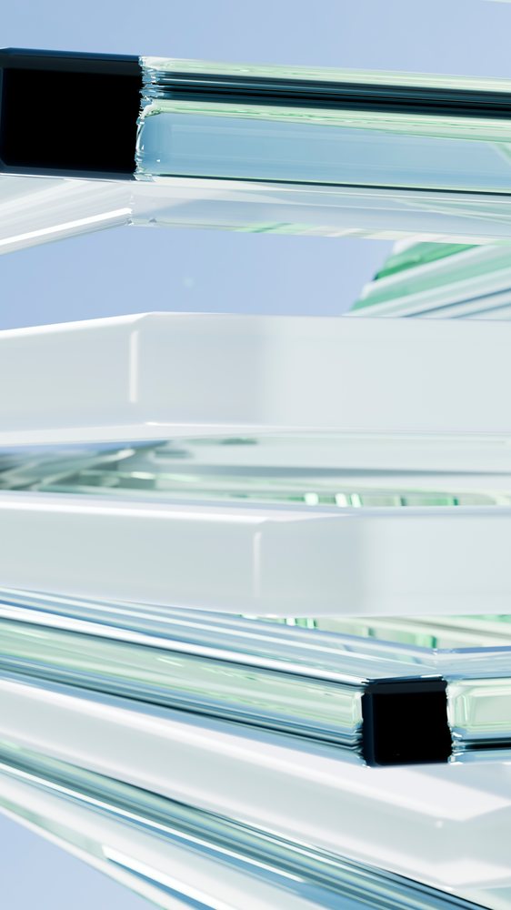 Stacked transparent glass and white framed blocks form a modern abstract design against a light blue background.