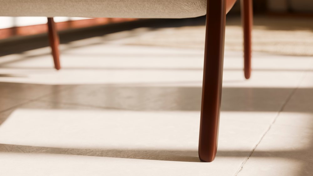 Wooden chair leg casting shadow on tiled floor in a modern interior space with sunlight.