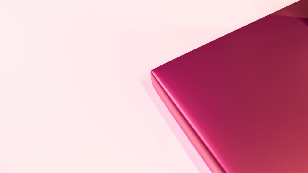 Closed magenta laptop with sleek modern design on a light background.