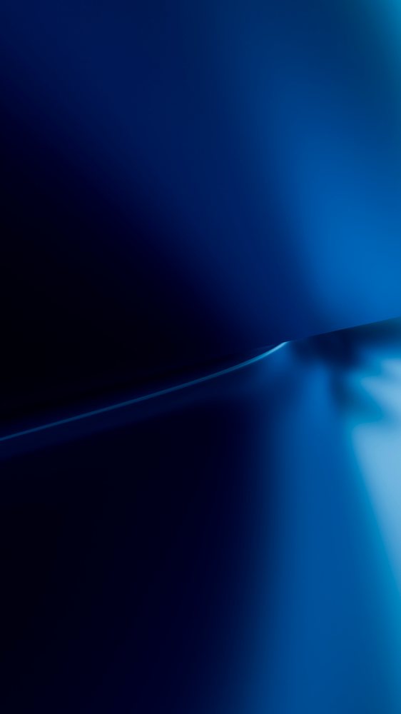 Abstract gradient blue background with smooth light and dark transitions creating a soft flowing effect.