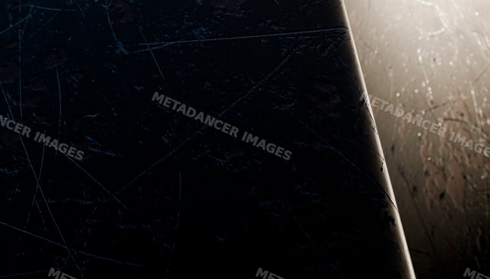 Close-up of scratched and worn dark metal surface under dim lighting